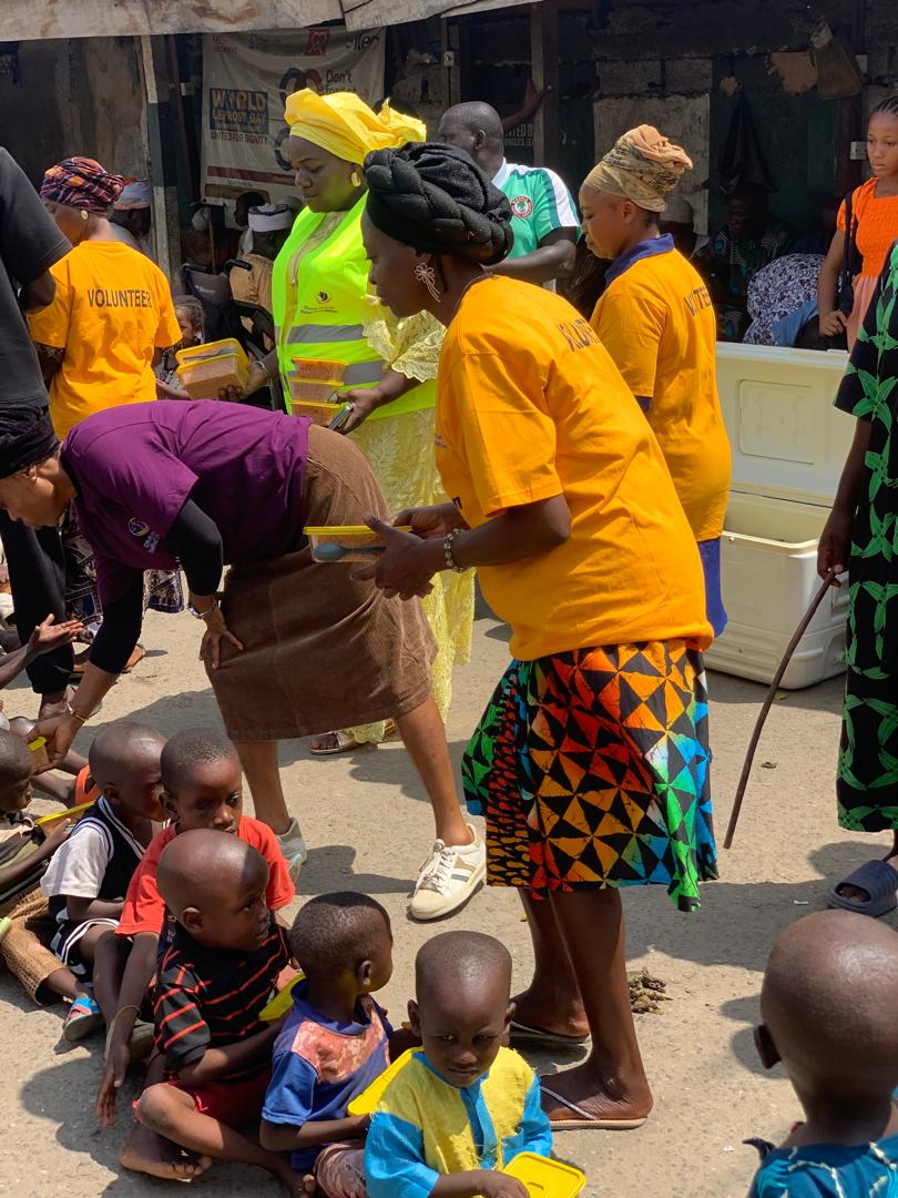 Lady giving food
          to the less privileged